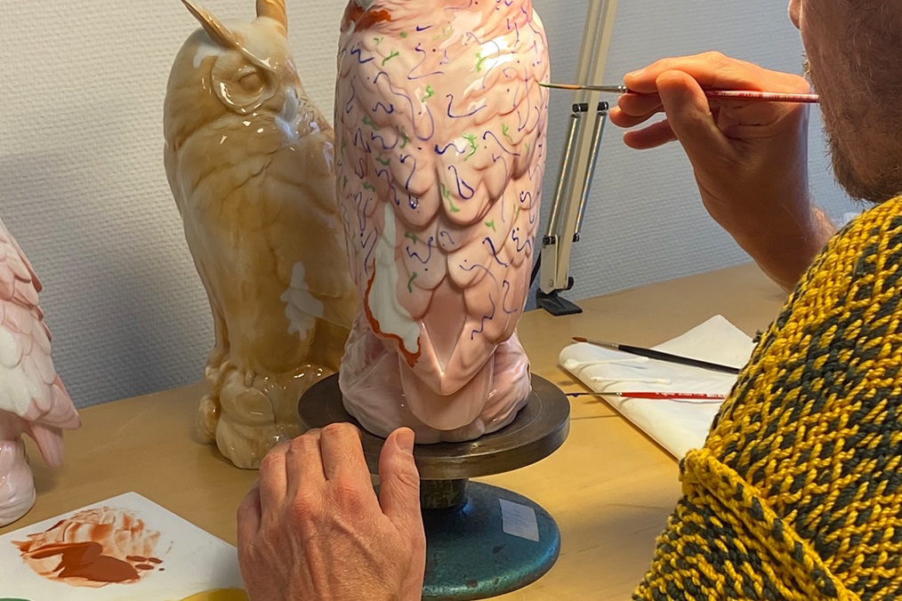 a close up of the designer painting one of the harald awards